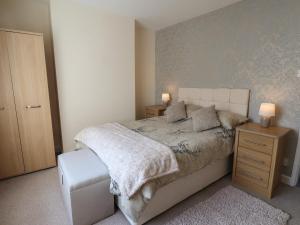 a bedroom with a bed with two night stands and two lamps at Field View in Saltburn-by-the-Sea