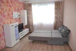a small living room with a couch and a tv at Julia Apartment Riga Imanta in Rīga