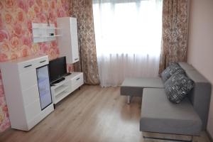 a small living room with a couch and a tv at Julia Apartment Riga Imanta in Rīga