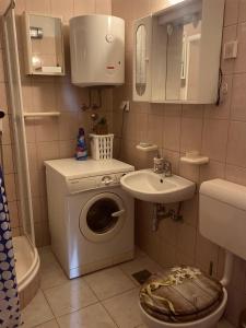a small bathroom with a toilet and a sink at Apartment Niko in Split