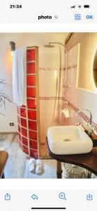 a bathroom with a shower and a white sink at Villa with pool close to the sea in Saint-Gilles les Bains
