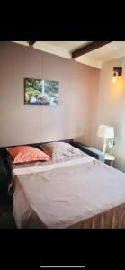 a bed in a bedroom with a picture on the wall at Villa with pool close to the sea in Saint-Gilles les Bains