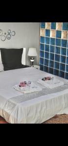 a bed with two towels on top of it at Villa with pool close to the sea in Saint-Gilles les Bains