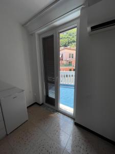 a room with a large window and a view of a pool at CETARA - ALBERGO DIFFUSO in Cetara