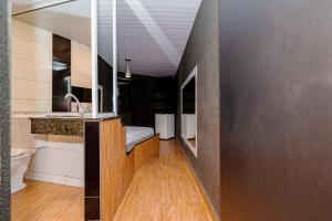 a bathroom with a sink and a counter top at Drops Express Motel Curitiba in Curitiba