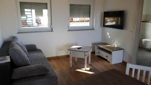 a living room with a couch and a table at Ferienwohnung Schoch in Rust