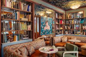 a living room with a couch and bookshelves at La Fantaisie in Paris