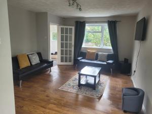 a living room with two couches and a table at Beautiful 3-Bed House in Ramsgate in Ramsgate