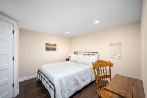 a bedroom with a bed and a wooden table at Country Cottage Basement Apartment in Hayden