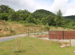 a fence in a field next to a road at Gîte Le Scarabée in Saint Die