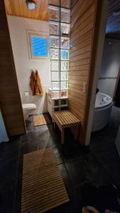 a bathroom with a tub and a toilet and a sink at Arctic Circle Luxury House - close to Santa's Village in Rovaniemi