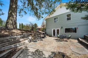 a stone patio in front of a house at Country Cottage Basement Apartment in Hayden