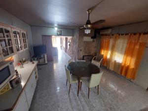 a living room with a table and chairs in it at La casa de los abu in Maipú
