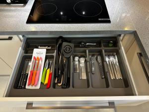a drawer filled with utensils in a kitchen at Side Holiday House in Side