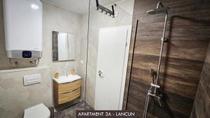 a bathroom with a shower with a toilet and a sink at Casa Mili Jezera in Jezera