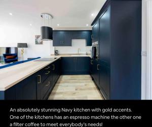an absolutely stunning navy kitchen with gold accents one of the kitchens has an espresso machine at The Old School Sleeps 14 in Lymington