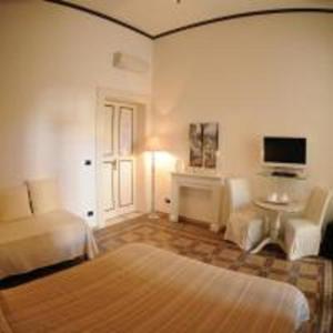 a living room with a bed and a tv at Casa Blanca in Reggio di Calabria