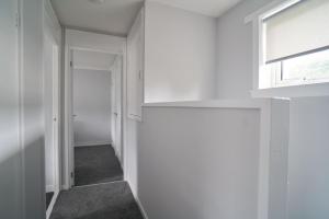 an empty hallway with a window and a door at Couver House in Livingston