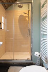 a shower with a glass door in a bathroom at Lake View Lodges in Long Melford