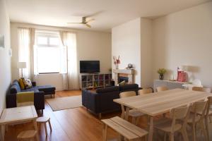a living room with a table and a couch at Link Alcácer in Alcácer do Sal