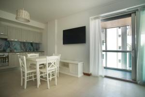 a kitchen with a table and chairs and a television at Vespucci Home in Rimini