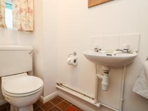 a bathroom with a toilet and a sink at Sea Star in Porthleven