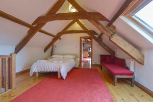 a bedroom with a bed and a red rug at Haye Barton Farm in Liskeard