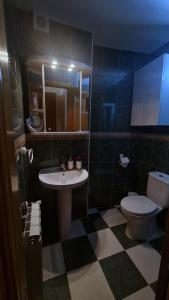 a bathroom with a sink and a toilet at Las Golondrinas de Henche 