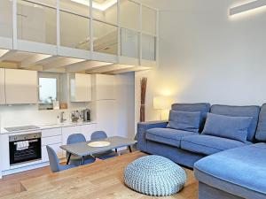 a living room with a blue couch and a table at "La Portineria" Charming Apartment Old Town Como Lake in Como