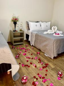 a room with a bed with roses on the floor at Pousada Dona Tereza in Guapé