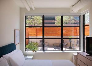 a living room with a white couch and a large window at Roost Baltimore in Baltimore