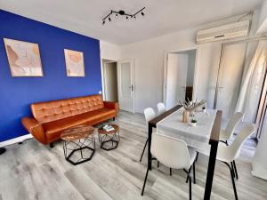 a dining room with a couch and a table at Casa Tessita by Gloove in Alicante