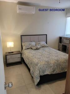 um quarto com uma cama e uma placa de quarto de hóspedes na parede em Departamento con espectacular vista a la montaña. em Puerto Vallarta