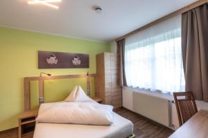 Voodi või voodid majutusasutuse Gästehaus Thomahan toas
