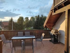 a patio with a table and chairs and a grill at Agroturystyka "U Kasi" in Ścinawka Górna