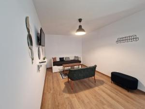 a living room with a table and a chair at Maximus Apartments in Sighişoara