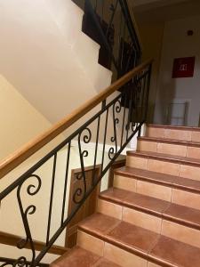 a set of stairs with a wrought iron railing at Apartment R in Risan