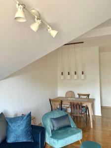 a living room with a blue couch and a table at Apartment R in Risan