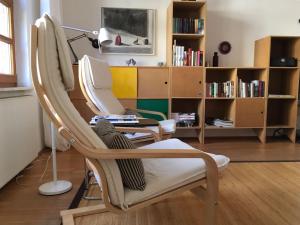 a room with a chair and a table with a mirror at Art-Apartment-Leo in Bremerhaven