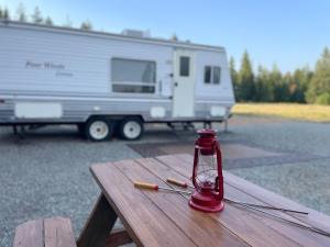 a red bottle on a picnic table next to a trailer at Quiet Country Rimrock Retreat in Hayden