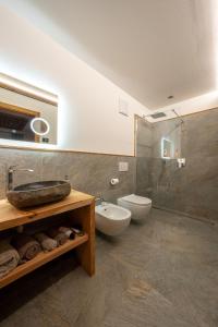 a bathroom with a sink and a toilet at Ciasa Marizana in Soraga