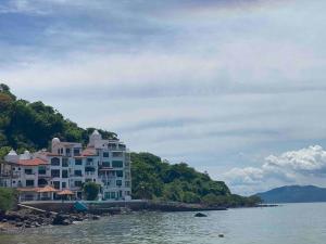 a large building on the shore of a body of water at Live an adventure in Taboga 1 in Taboga