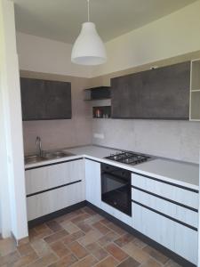 a kitchen with a sink and a stove top oven at Serroni Alto in Battipaglia