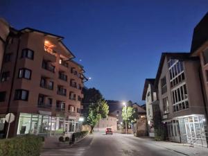 a car driving down a city street at night at Apartman Gold City 2 Studio in Fojnica
