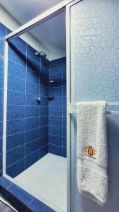 a bathroom with a shower with a towel at Hotel Beijing Cartagena in Cartagena de Indias