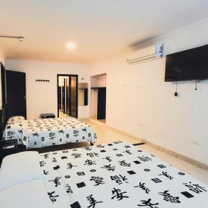 Postel nebo postele na pokoji v ubytování Hotel Beijing Cartagena