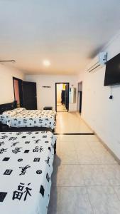 Postel nebo postele na pokoji v ubytování Hotel Beijing Cartagena