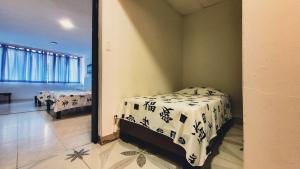 Postel nebo postele na pokoji v ubytování Hotel Beijing Cartagena