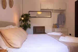 a bedroom with a white bed and a closet at Tusa Bay in Castel di Tusa