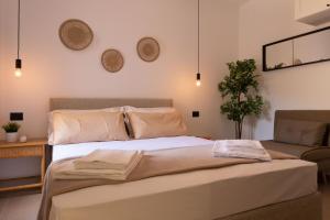 a bedroom with a large bed and a couch at Tusa Bay in Castel di Tusa